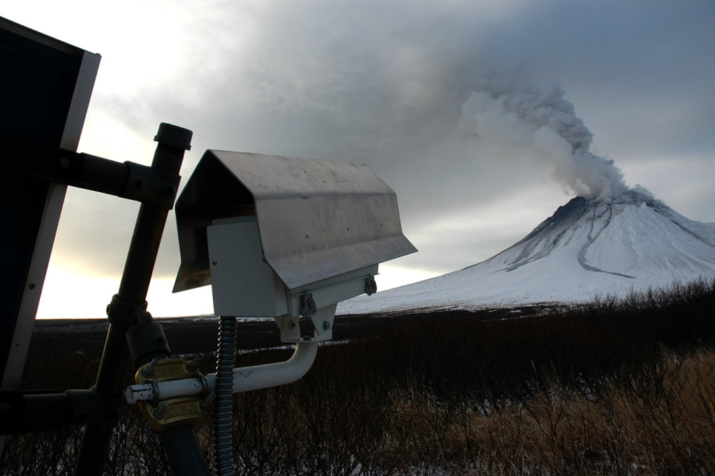 Mound camera focused on Mount Augustine. The camera's housing has a protective debris- and snow-shedding shield of bent aluminum. The housing is mounted to an Alaska Volcano Observatory solar-panel structure. Taken January12, 2006 / Courtesy USGS Michelle Combs